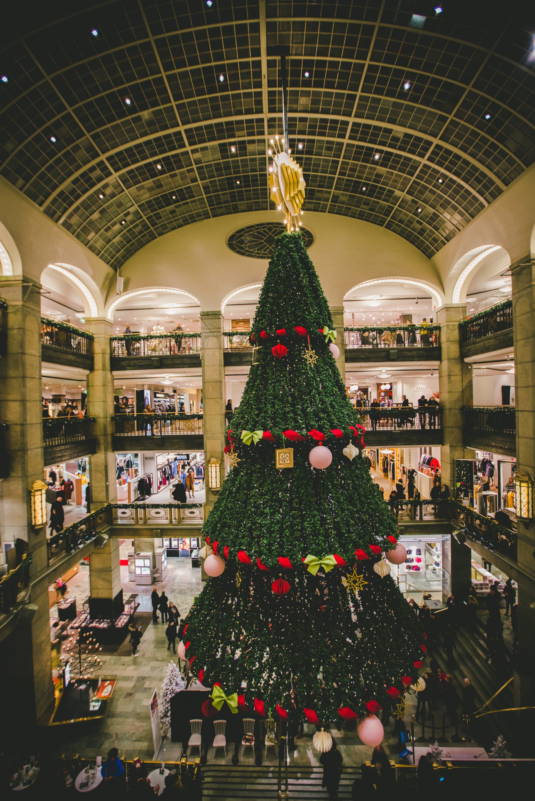 A multi-cone Christmas tree décor that features decorative elements like balloons and red ornamentation.