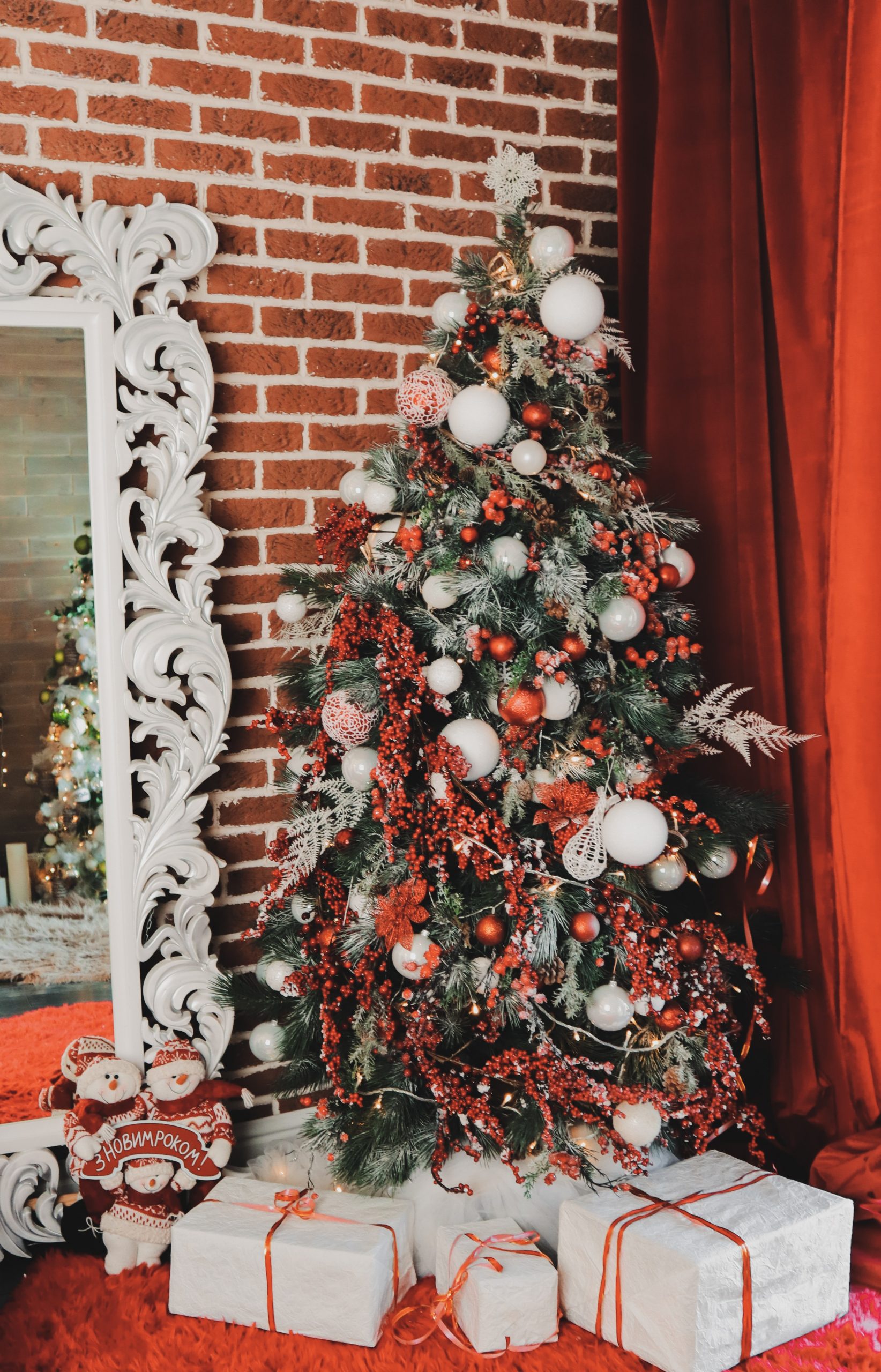 A red and white themed Christmas tree décor featuring a wide array of decorative elements.