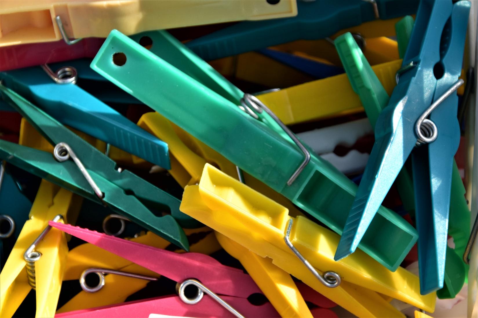 Different colors of clothespin put together.