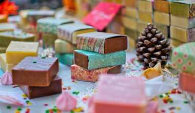 Numerous different kinds of handmade soaps placed together in a colorful setting.