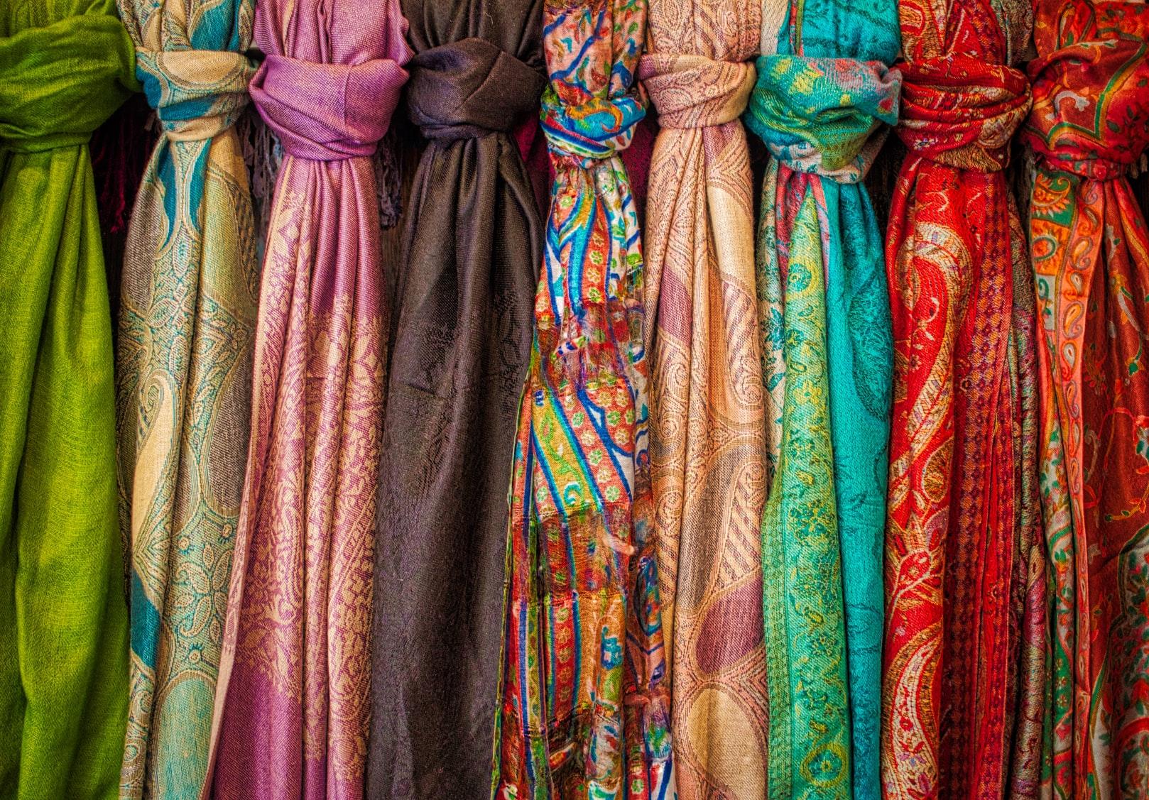 Fabric in line Multiple colored fabrics knotted to a railing.