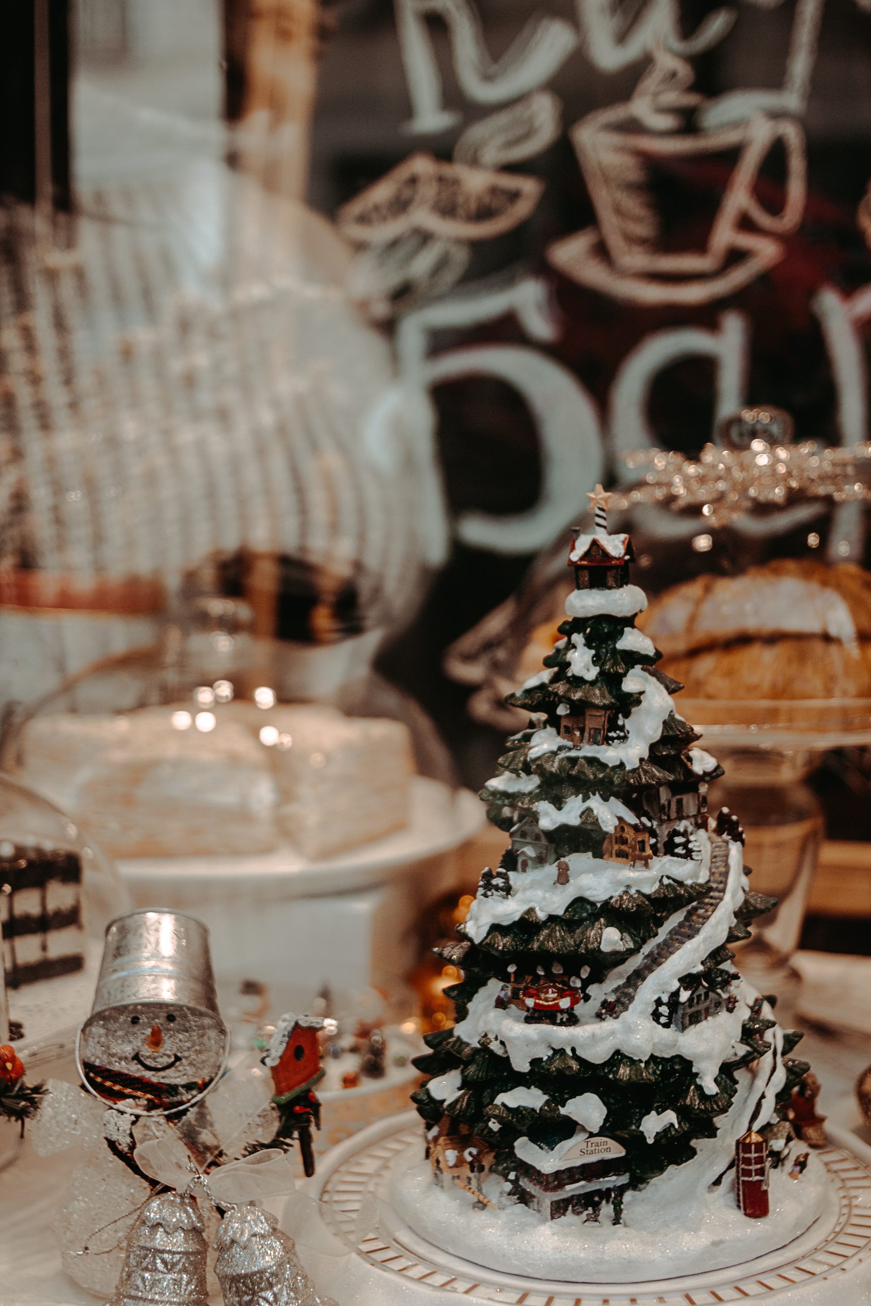 A miniature Christmas tree surrounded by other Christmas-themed ornamentation at a winter wedding