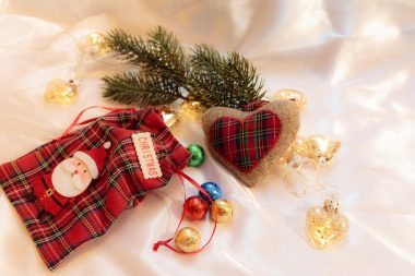 Buffalo plaid checkered Christmas ornaments in different color combinations, including blue, black, red, green, brown, and white and different shapes