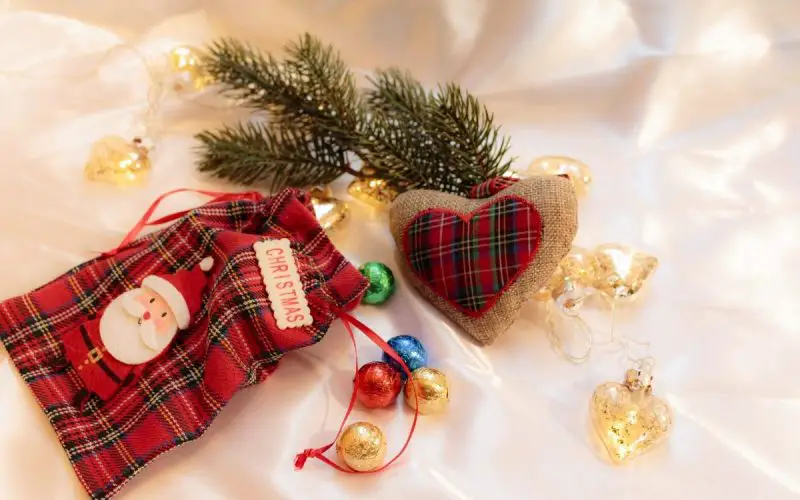 Buffalo plaid checkered Christmas ornaments in different color combinations, including blue, black, red, green, brown, and white and different shapes