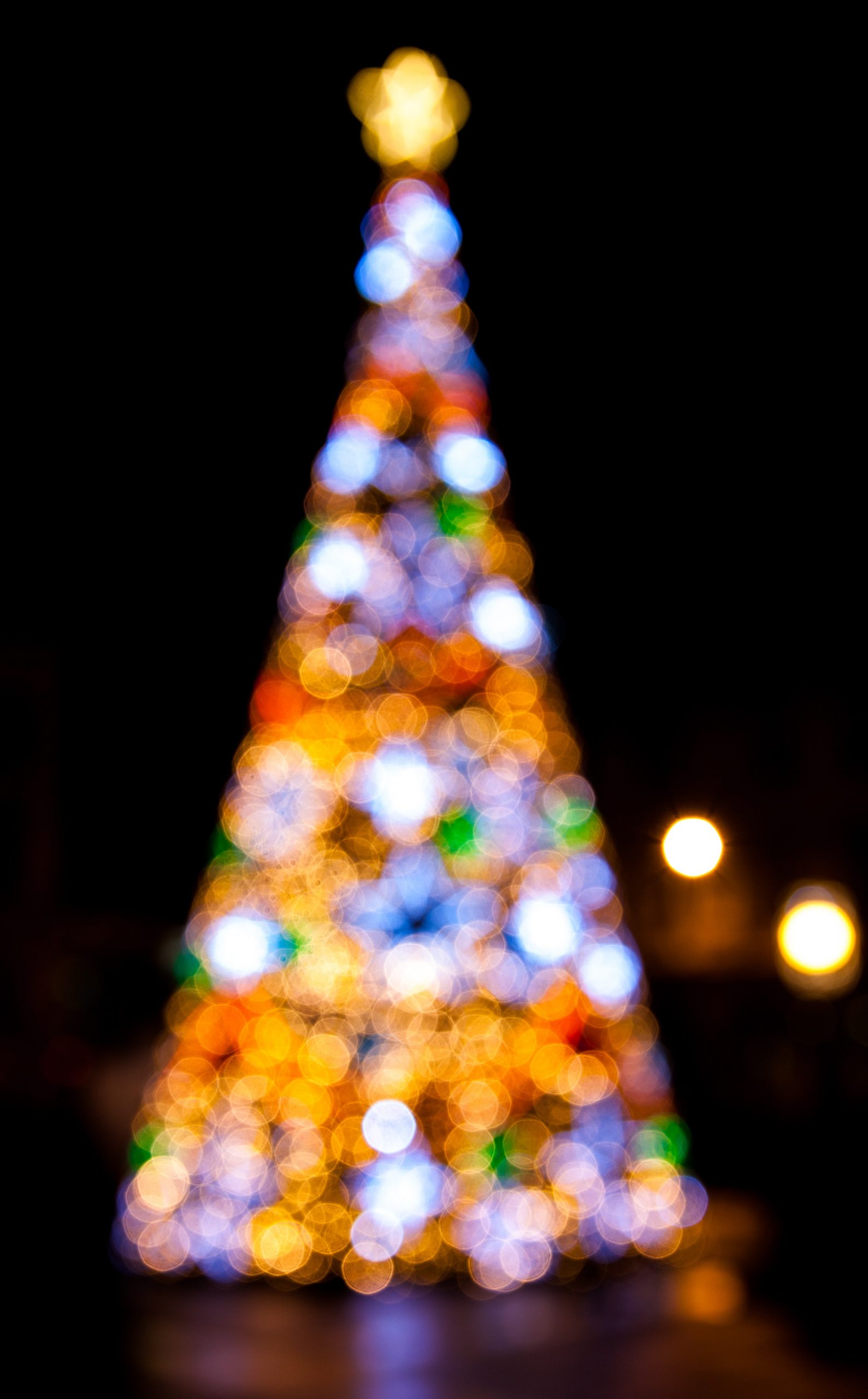Christmas tree lights A Christmas iPhone wallpaper of a lit up Christmas tree