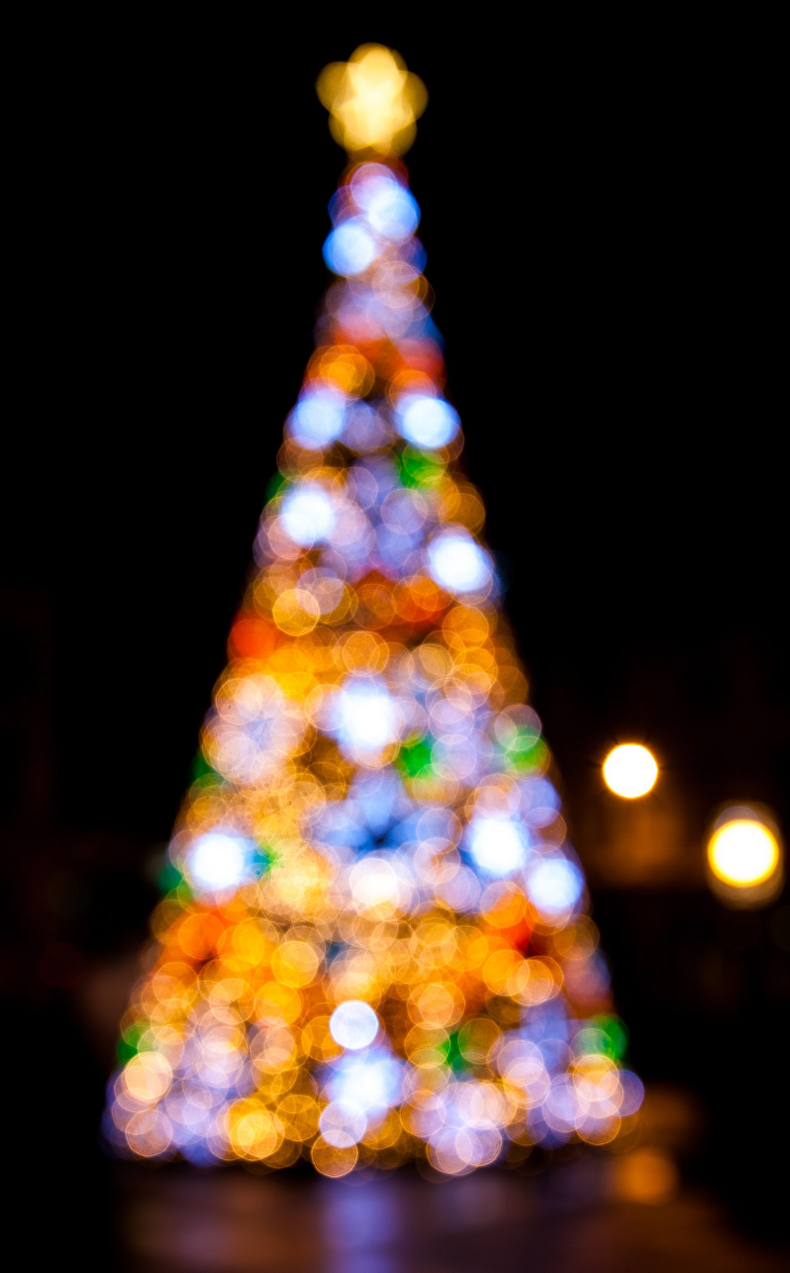 A Christmas iPhone wallpaper of a lit up Christmas tree