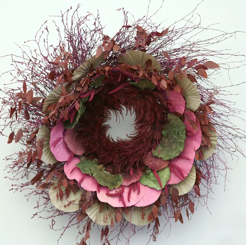 A Christmas wreath with dried flowers and leaves designed in a pattern