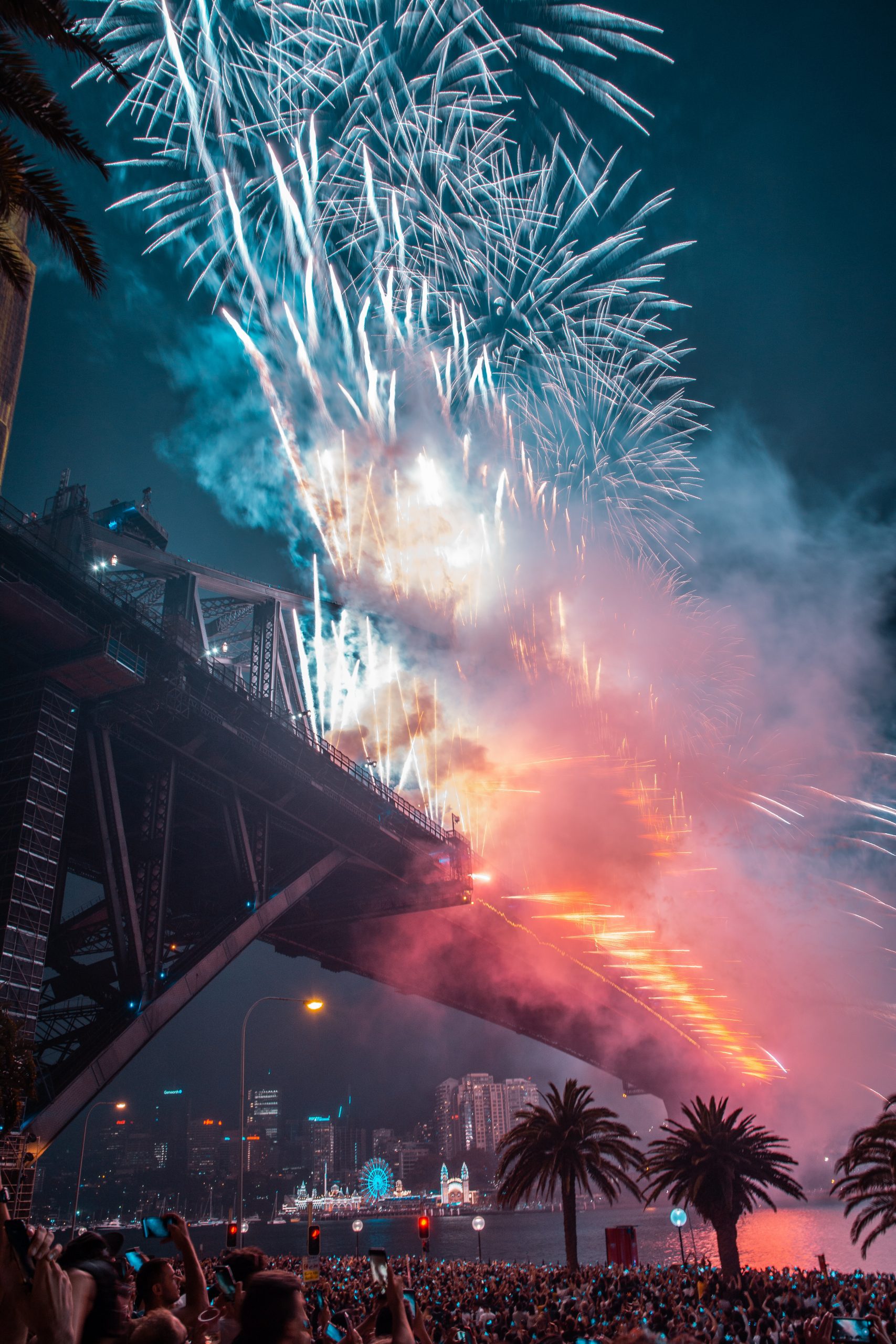 An iPhone Christmas wallpaper of fire work display with people watching