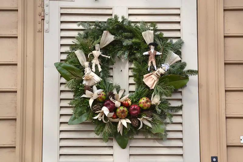 A Christmas wreath with miniature handmade dolls and fruits