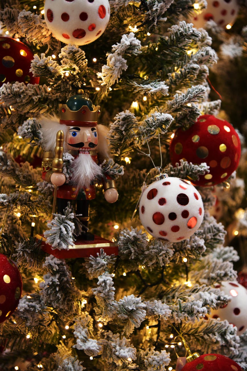 A nutcracker ornament on a Christmas tree