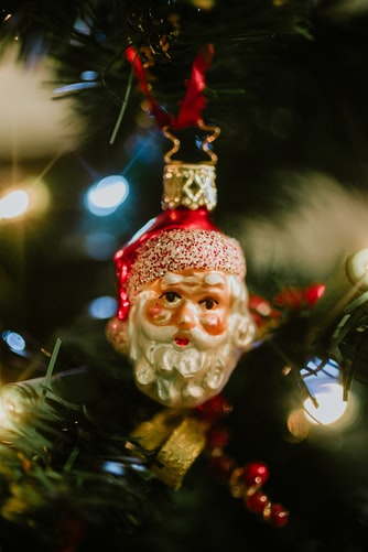 Santa Claus ornament hanging on a Christmas tree