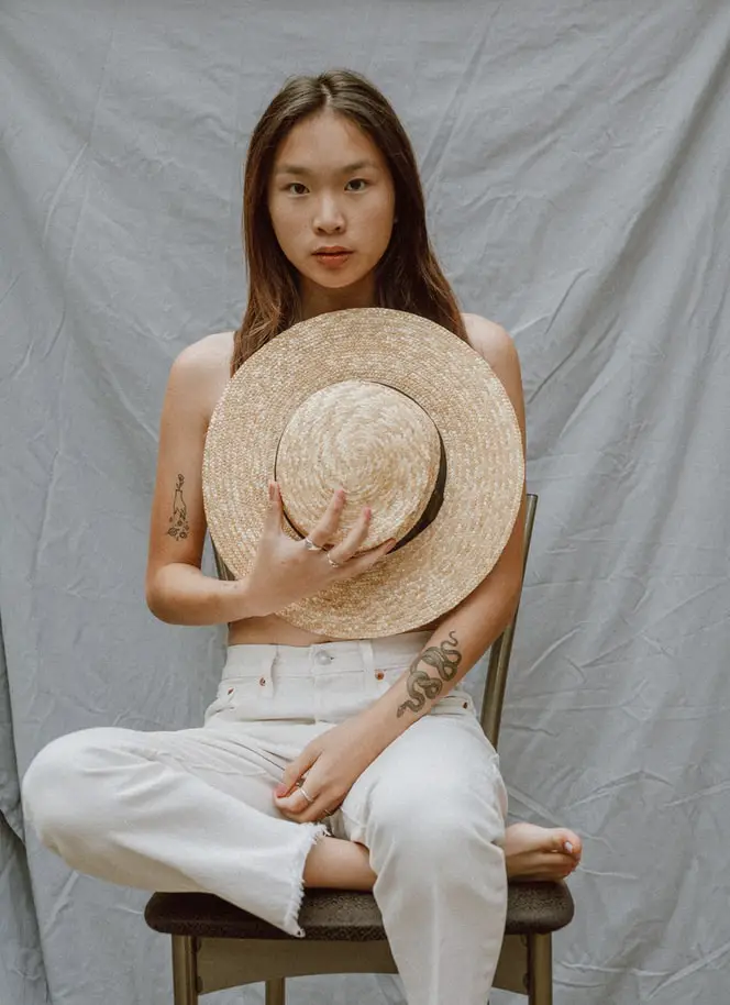 A lady showing her small snake tattoos printed on her arm