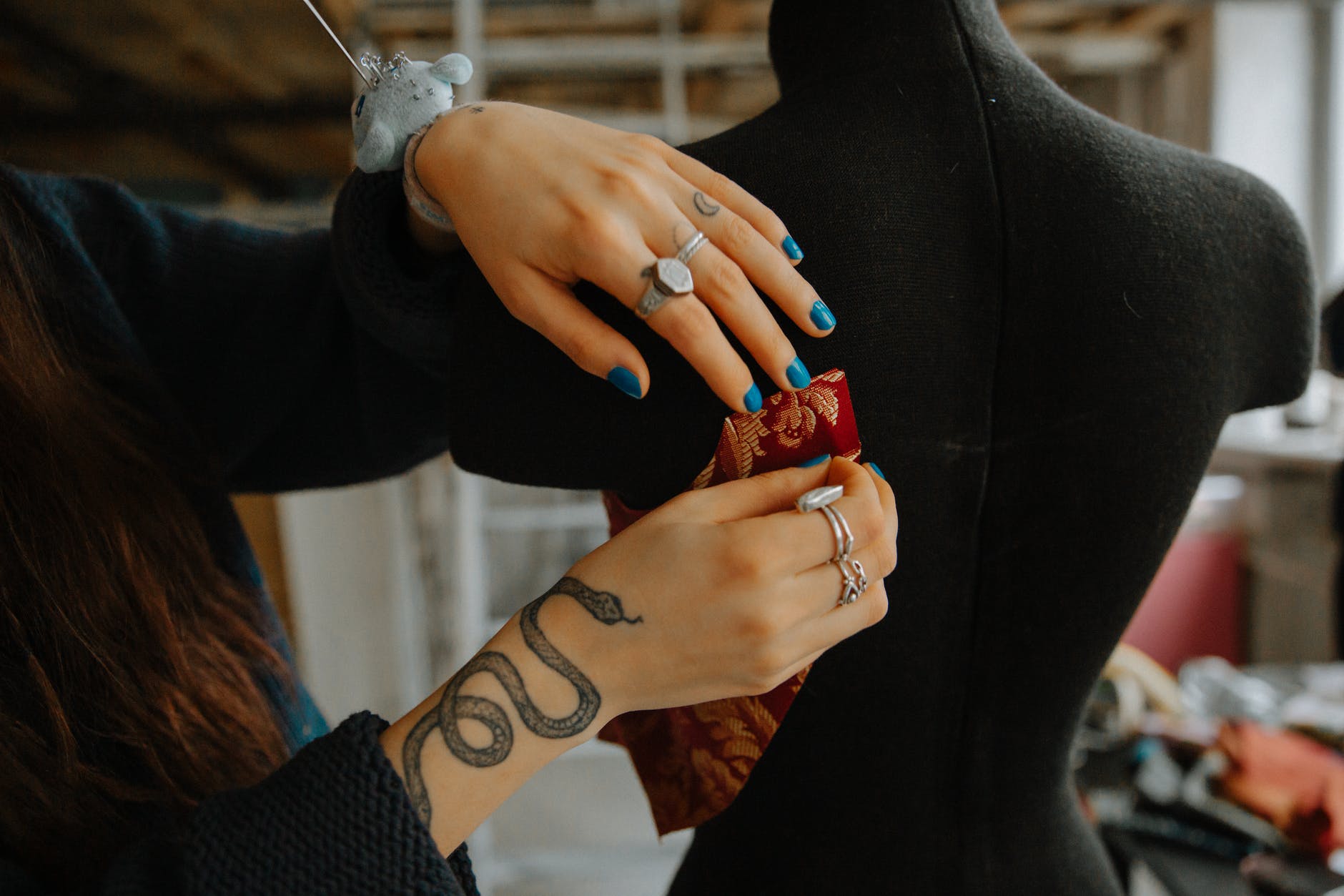 A woman showing her rattlesnake tattoo on her right hand